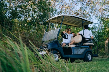 Two passengers chatting in a golf cart
